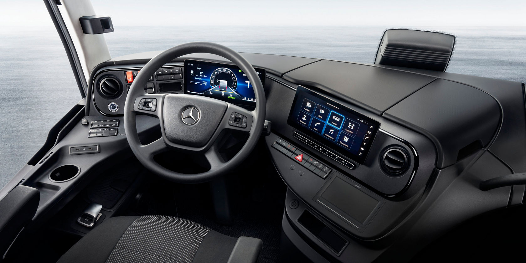 Driver cockpit in the Mercedes-Benz Tourismo coach with steering wheel, digital instrument cluster and central touch display in the cockpit