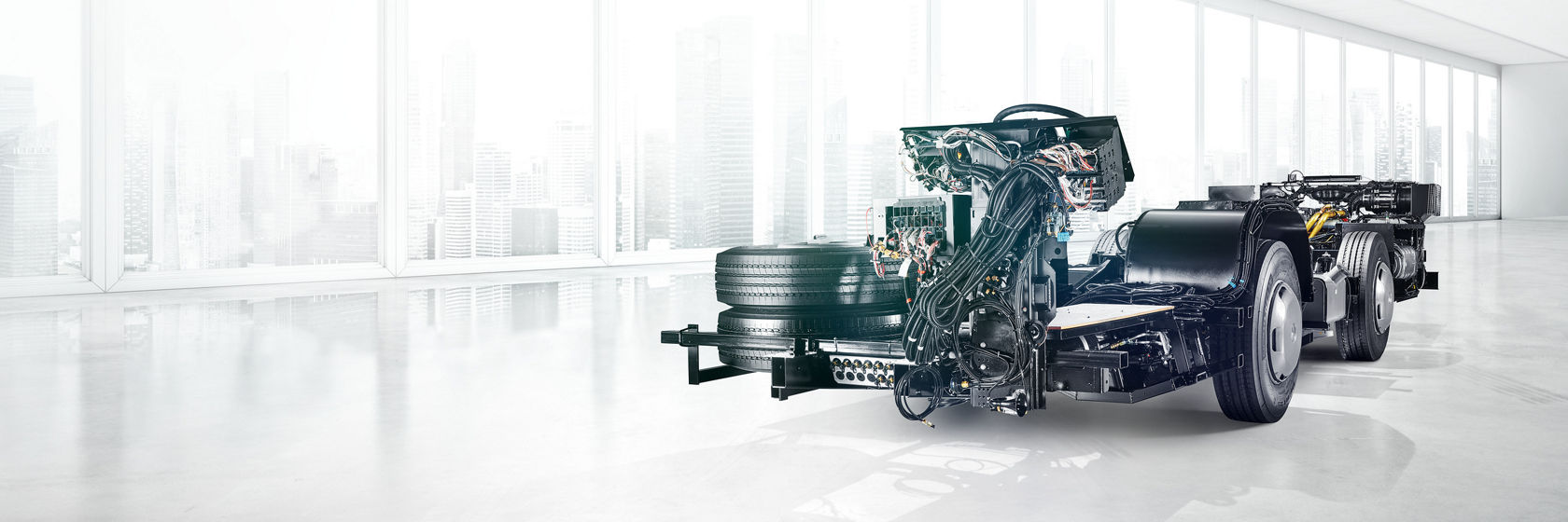 Mercedes-Benz chassis with exposed components and wiring in a light studio, side view