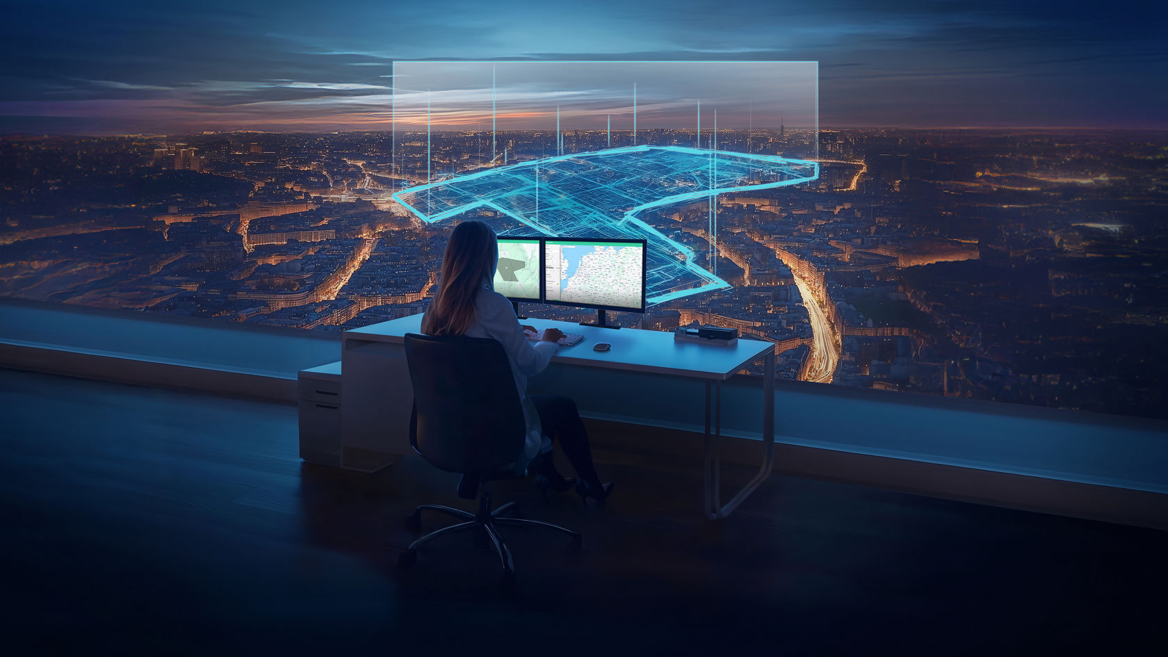 Person at a workstation looking at a digital city view with visualised borders within the urban area.